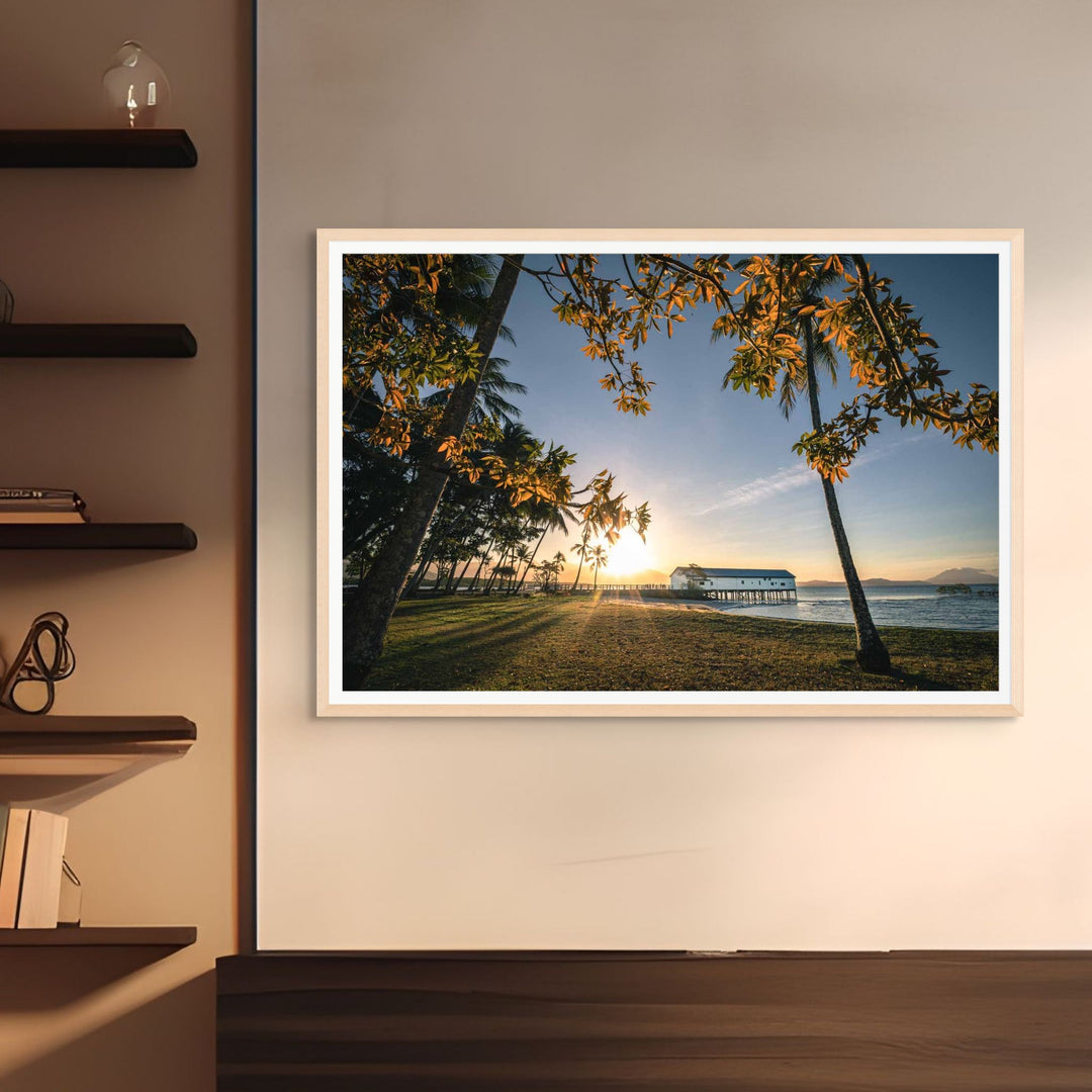 Autumn Sugar – Landscape photograph of the Sugar Wharf in Port Douglas framed by autumn leaves with golden sunset light | Framed Paper Print