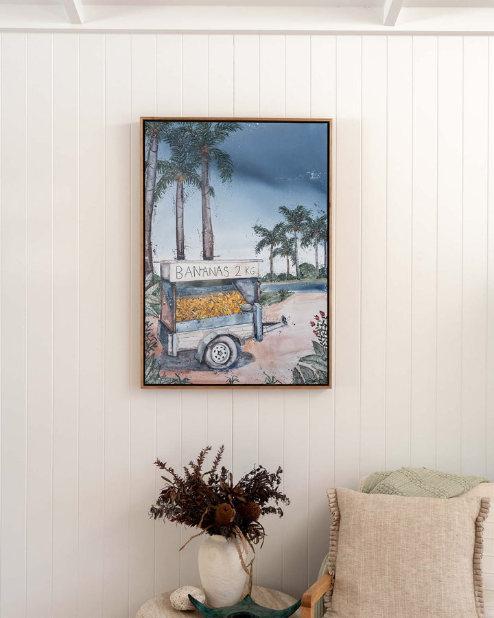Banana Cart – tropical still life of a banana cart, framed canvas in oak float frame, styled in a bedroom