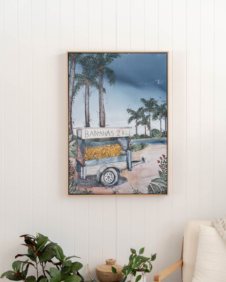 Banana Cart – tropical still life of a banana cart, framed canvas in oak float frame, styled in a hallway