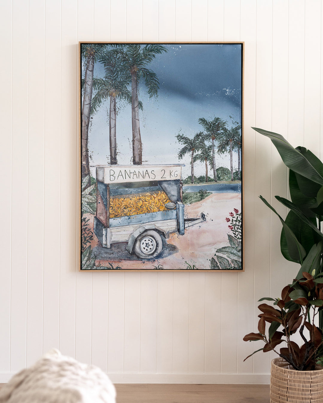 Banana Cart – tropical still life of a banana cart, framed canvas in oak float frame, styled in a living room