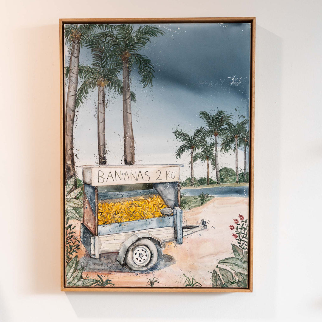 Banana Shack by Stephanie Elizabeth, acrylic painting of a BANANAS 2KG cart set on a sunny tropical beach.