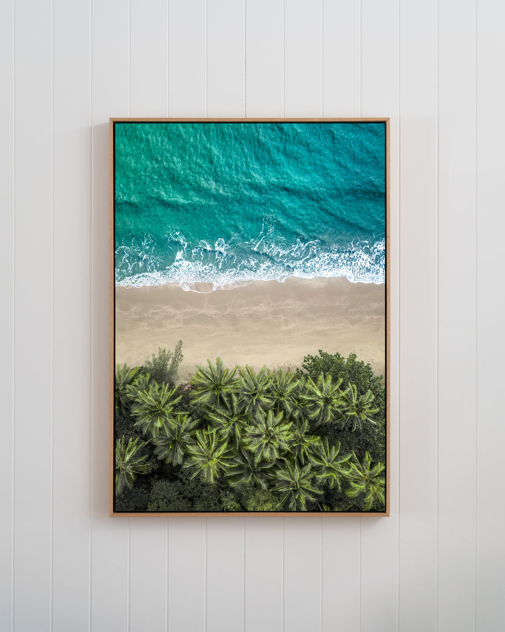 Aerial view of Four Mile Beach in Beachside Reverie, featuring turquoise waves and palm trees.