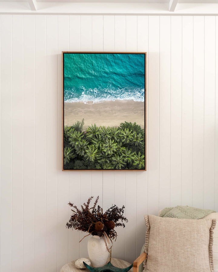 Beachside Reverie – Four Mile Beach, Aerial Photography by David Lloyd, framed canvas print in oak float frame, styled in a bedroom setting