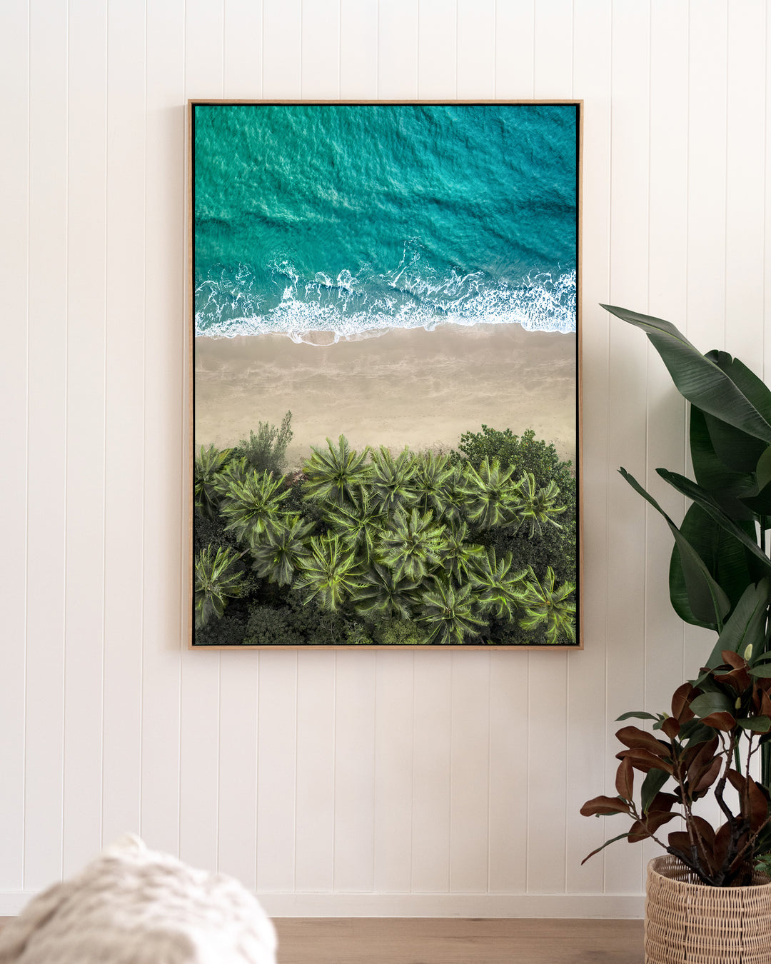 Beachside Reverie – Four Mile Beach, Aerial Photography by David Lloyd, framed canvas print in oak float frame, styled in a living room setting