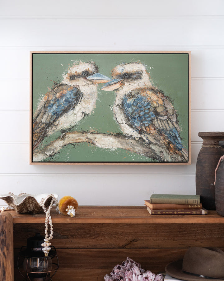 Beaks and Bedlam kookaburra fine art print by Stephanie Elizabeth, framed canvas in an oak frame above a bookshelf