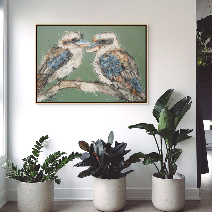 Framed presentation of Beaks and Bedlam by Stephanie Elizabeth featuring two kookaburras perched on a branch in a modern interior.