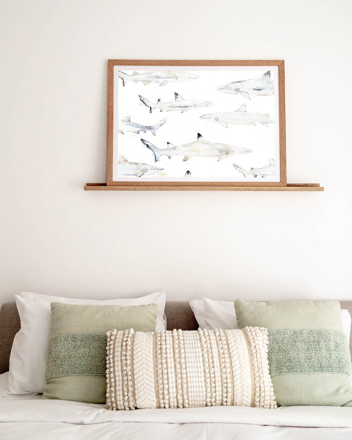 Black or White reef sharks fine art print by Stephanie Elizabeth, framed paper print in an oak frame in a bedroom