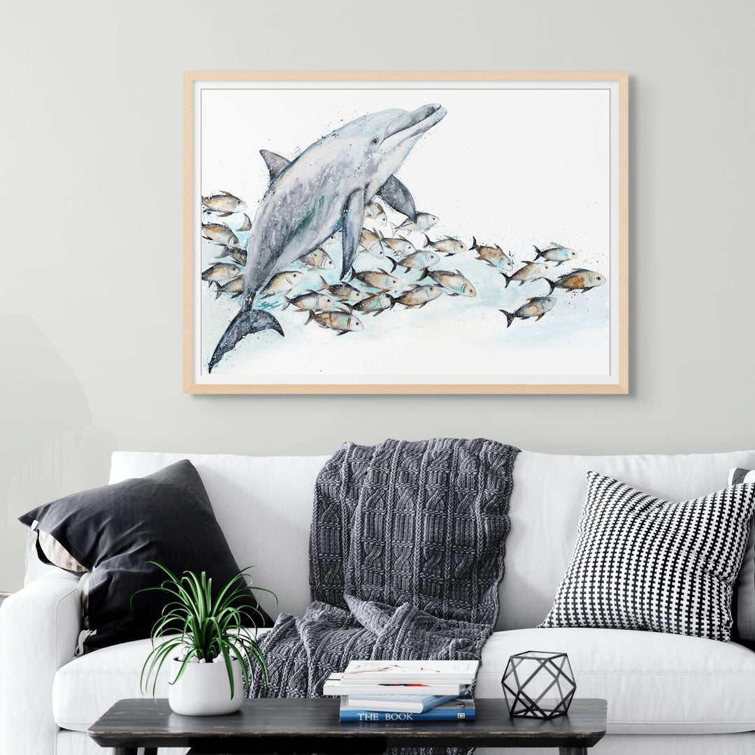 Bubble Toes by Stephanie Elizabeth – framed paper print of playful dolphin surrounded by trevally, fine art marine life print