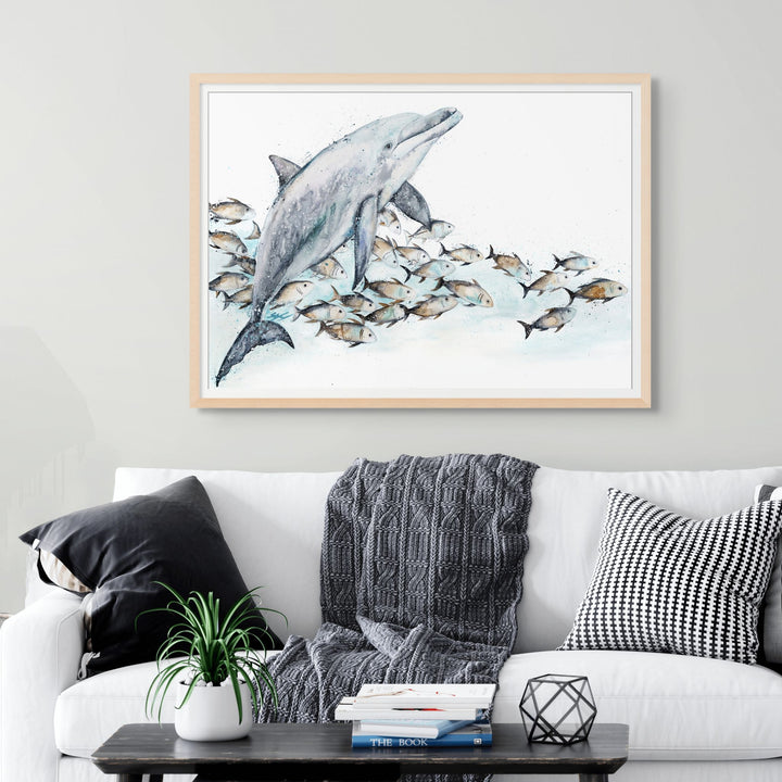 Bubble Toes by Stephanie Elizabeth – framed paper print of playful dolphin surrounded by trevally, fine art marine life print