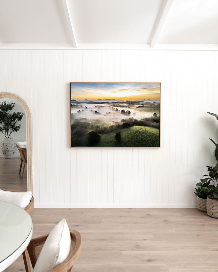 Campfire Smells and Fog Blankets – Atherton Tablelands, Aerial Photography by David Lloyd, framed canvas print in oak float frame, styled in a dining room setting
