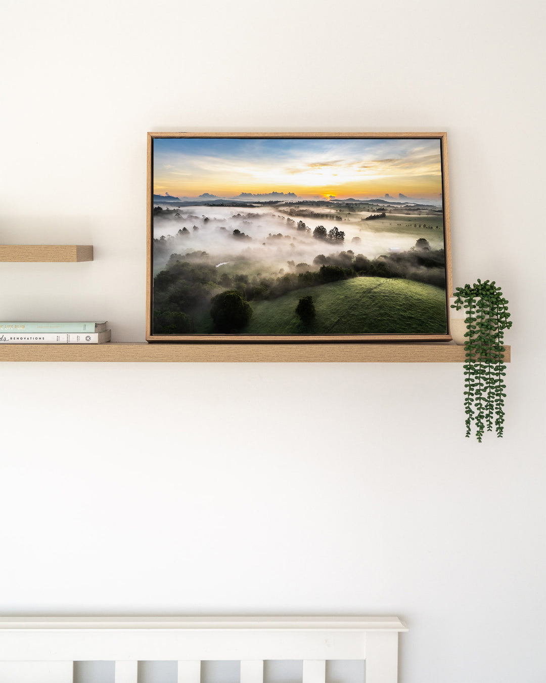 Campfire Smells and Fog Blankets – Atherton Tablelands, Aerial Photography by David Lloyd, framed canvas print in oak float frame, styled in a timber shelf setting