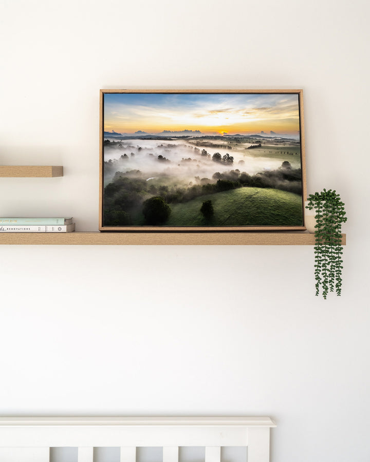 Campfire Smells and Fog Blankets – Atherton Tablelands, Aerial Photography by David Lloyd, framed canvas print in oak float frame, styled in a timber shelf setting