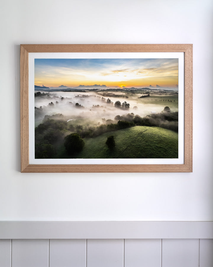 Framed print of Campfire Smells and Fog Blankets: Atherton Tablelands aerial photography hanging on a white wall.