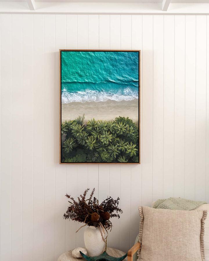 City of Palms – Four Mile Beach, Port Douglas, Aerial Photography by David Lloyd, framed canvas print in oak float frame, styled in a bedroom setting