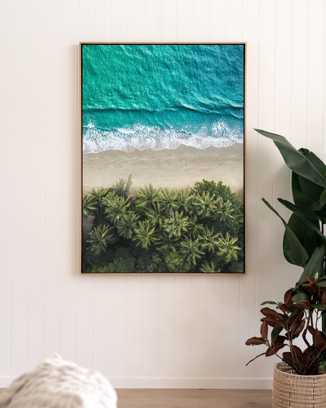 City of Palms – Four Mile Beach, Port Douglas, Aerial Photography by David Lloyd, framed canvas print in oak float frame, styled in a living room setting