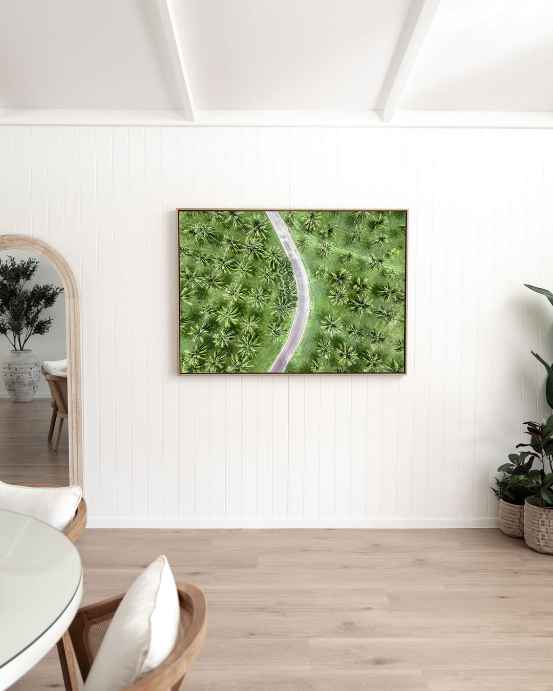 Coconut Coast – Thala Beach, Aerial Photography by David Lloyd, framed canvas print in oak float frame, styled in a dining room setting