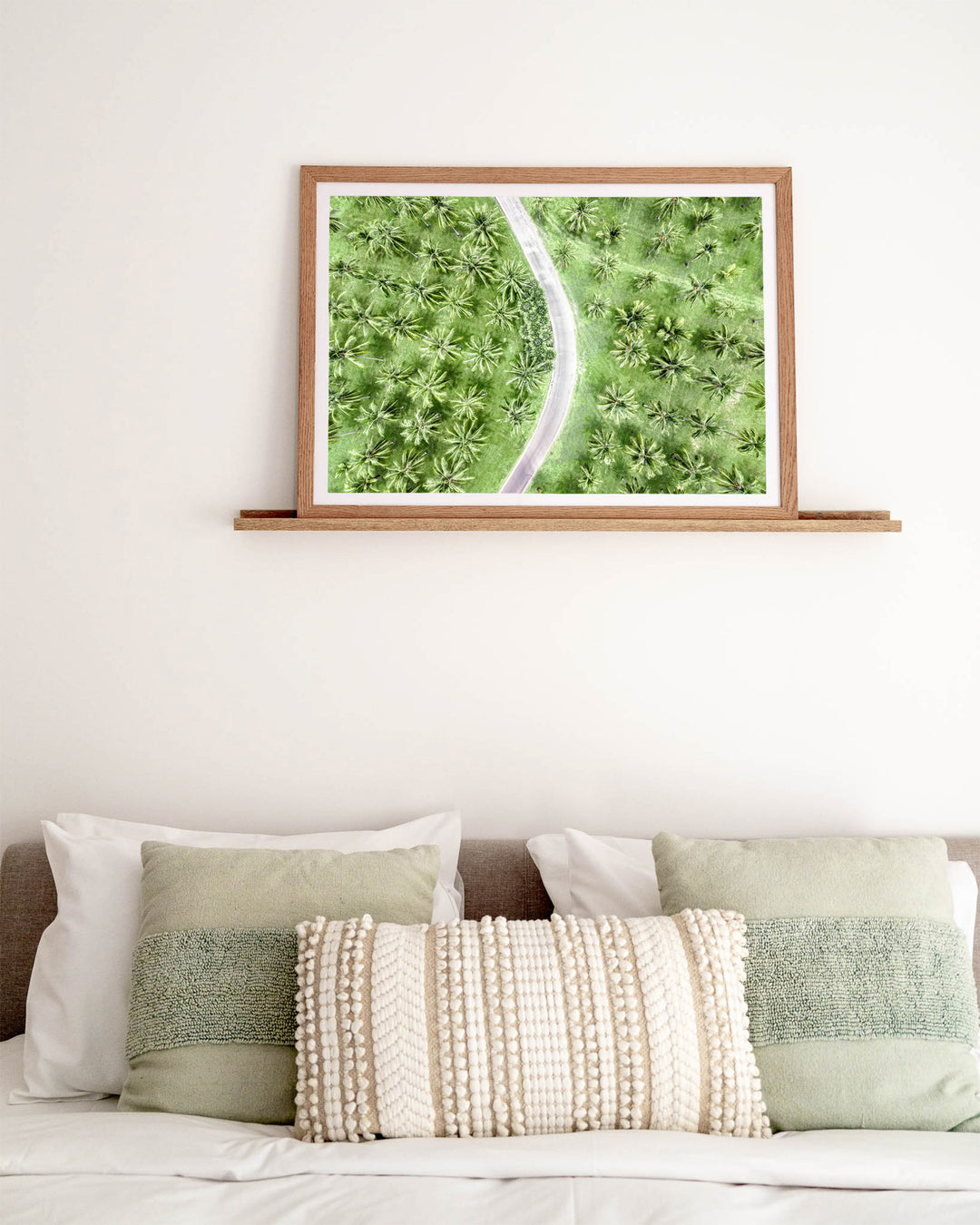 Coconut Coast – Thala Beach, Aerial Photography by David Lloyd, framed paper print in oak frame, styled in a bedroom setting