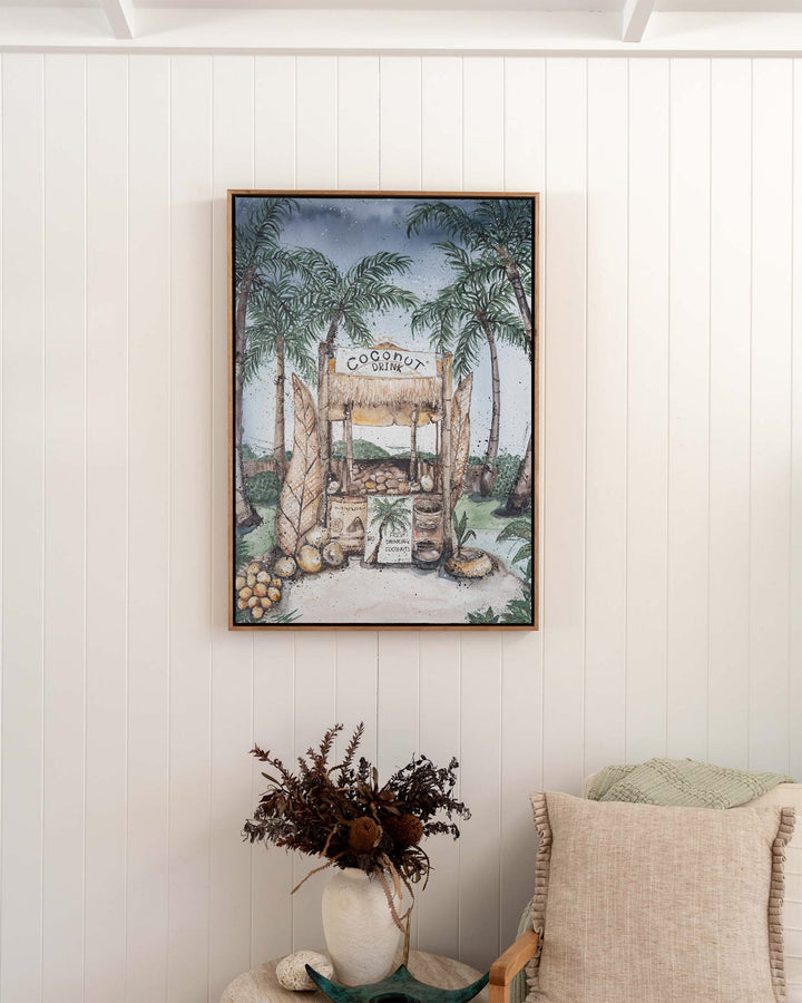Coconut Hut tropical still life fine art print by Stephanie Elizabeth, framed canvas in an oak frame in a bedroom