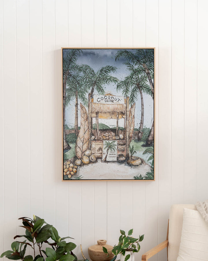 Coconut Hut tropical still life fine art print by Stephanie Elizabeth, framed canvas in an oak frame in a hallway