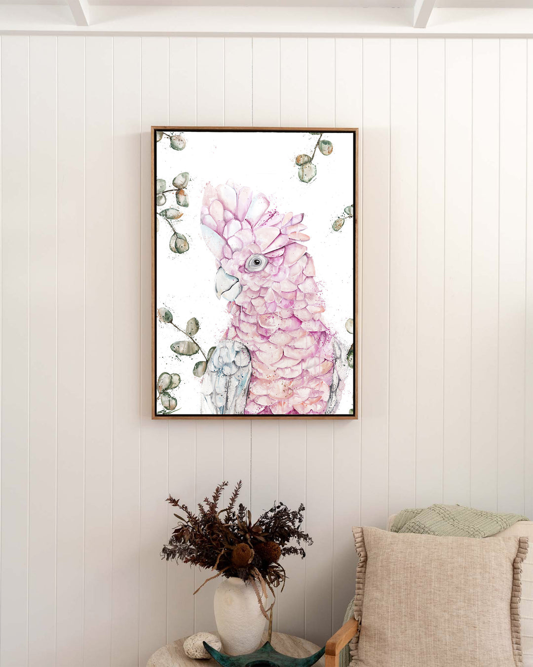 Coconut Ice pink galah fine art print by Stephanie Elizabeth, framed canvas in an oak frame in a bedroom