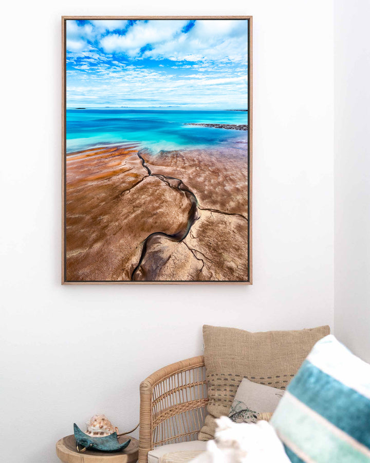 Cracks in the Ocean – Ocean Art, Aerial Photography by David Lloyd, framed canvas print in oak float frame, styled in a coastal lounge setting
