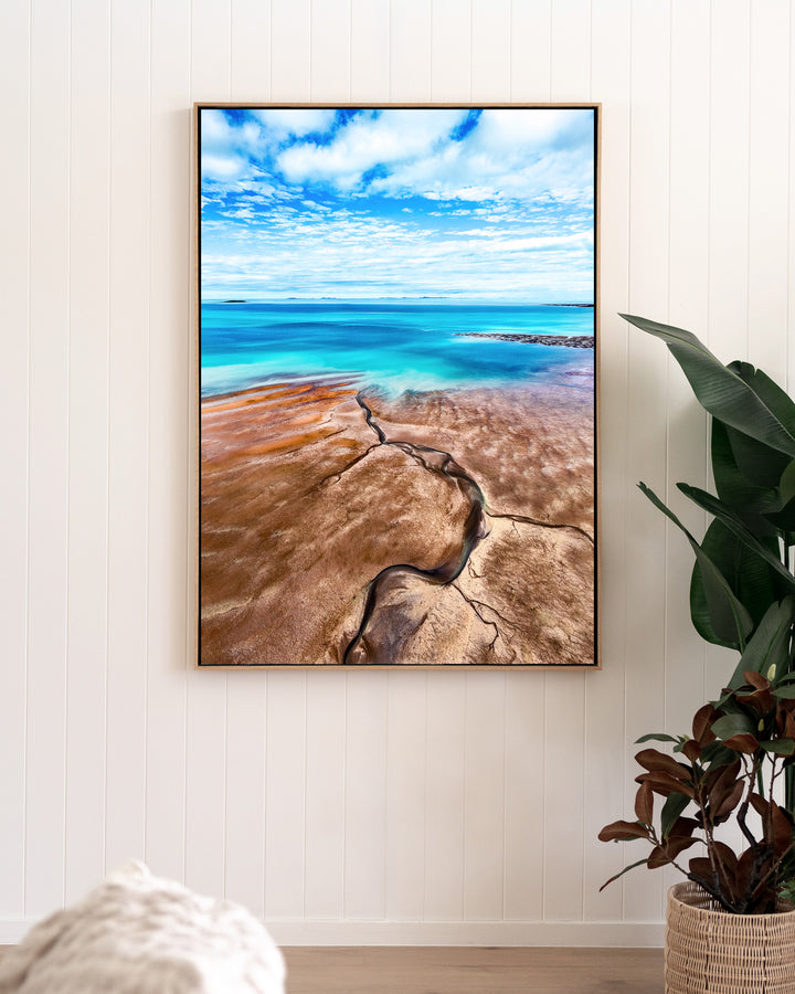 Cracks in the Ocean – Ocean Art, Aerial Photography by David Lloyd, framed canvas print in oak float frame, styled in a living room setting