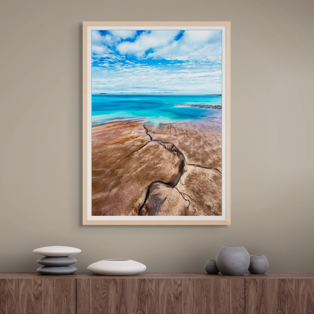 Cracks in the Ocean – Aerial view of textured brown sands and vivid blue ocean, low tide leading lines creating natural patterns | Framed Paper Print