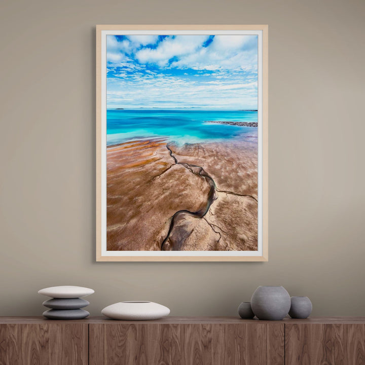 Cracks in the Ocean – Aerial view of textured brown sands and vivid blue ocean, low tide leading lines creating natural patterns | Framed Paper Print
