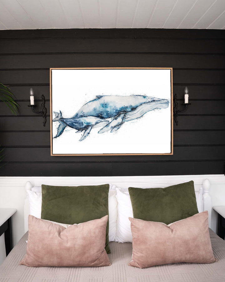 Crazy Love humpback whales fine art print by Stephanie Elizabeth, framed canvas in an oak frame in a bedroom