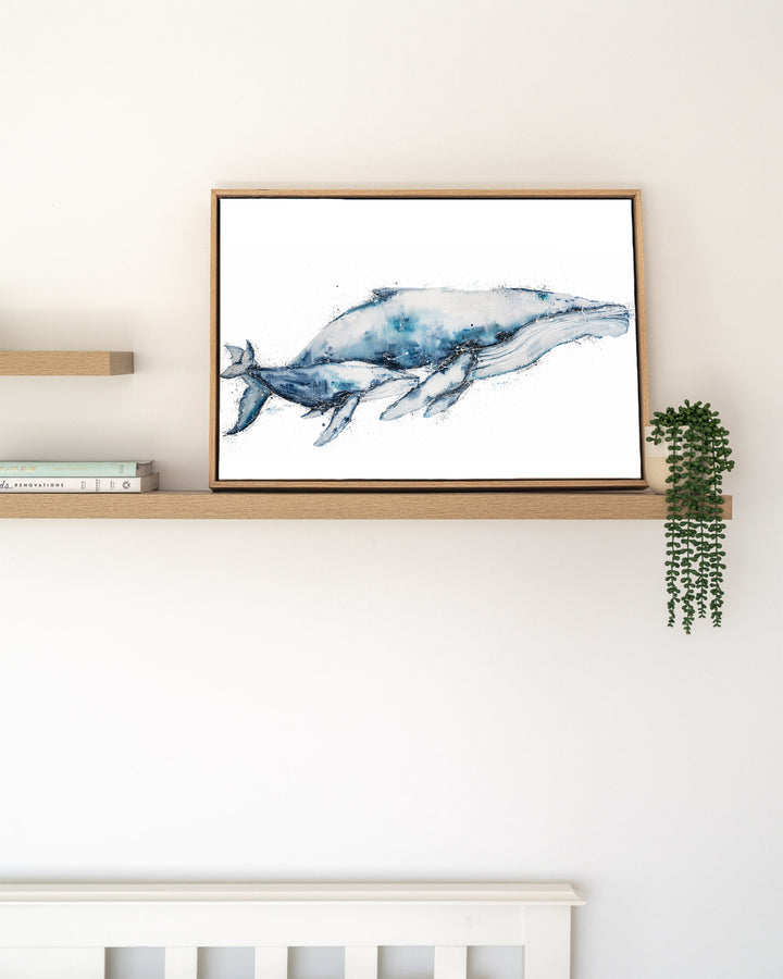 Crazy Love humpback whales fine art print by Stephanie Elizabeth, framed canvas in an oak frame on a shelf