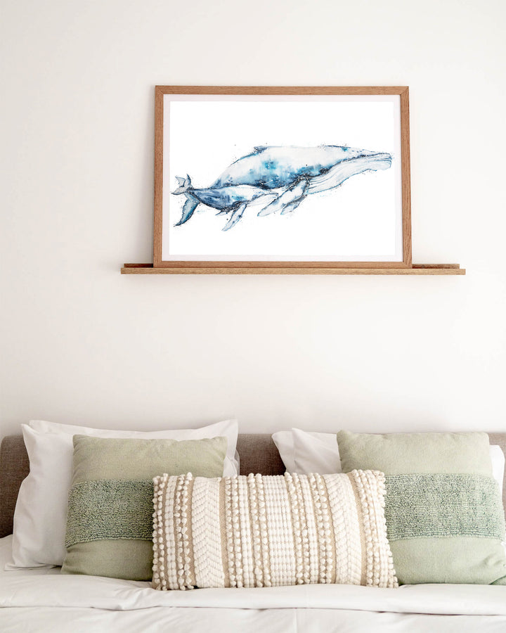 Crazy Love humpback whales fine art print by Stephanie Elizabeth, framed paper print in an oak frame in a bedroom