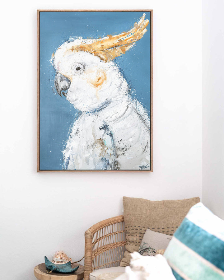 Crested Fiesta – white cockatoo, framed canvas in oak float frame, styled in a coastal lounge