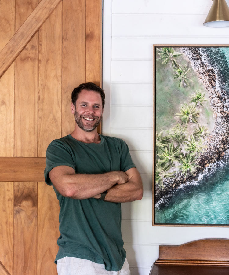 David Lloyd standing with aerial abstract artwork hanging on wall - framed canvas print