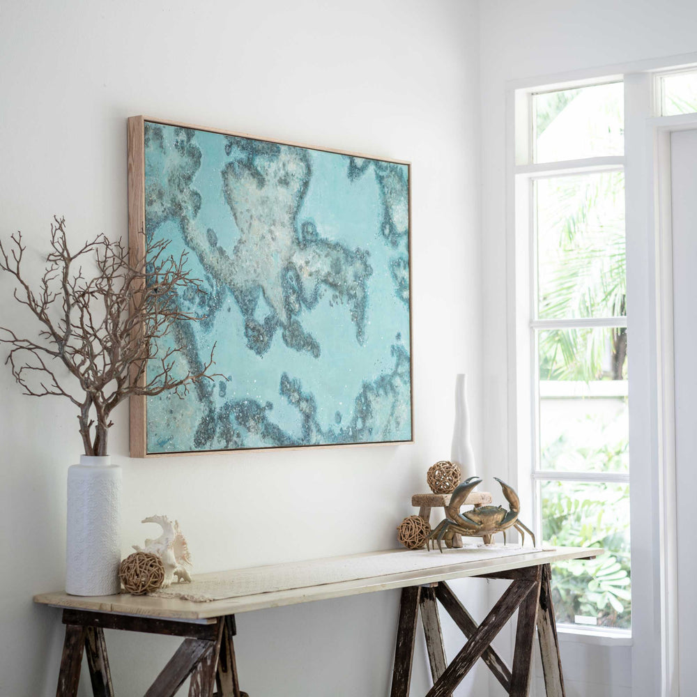 Diving Into You – aerial reef painting with rich blue ocean tones styled in relaxed interior with figure for scale by Stephanie Elizabeth | Original Artwork
