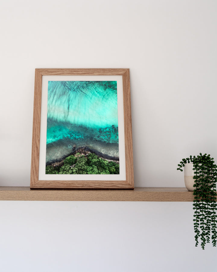 Don’t Dream It’s Over – Cape Tribulation, Aerial Photography by David Lloyd, framed paper print in oak frame, styled in a timber shelf setting