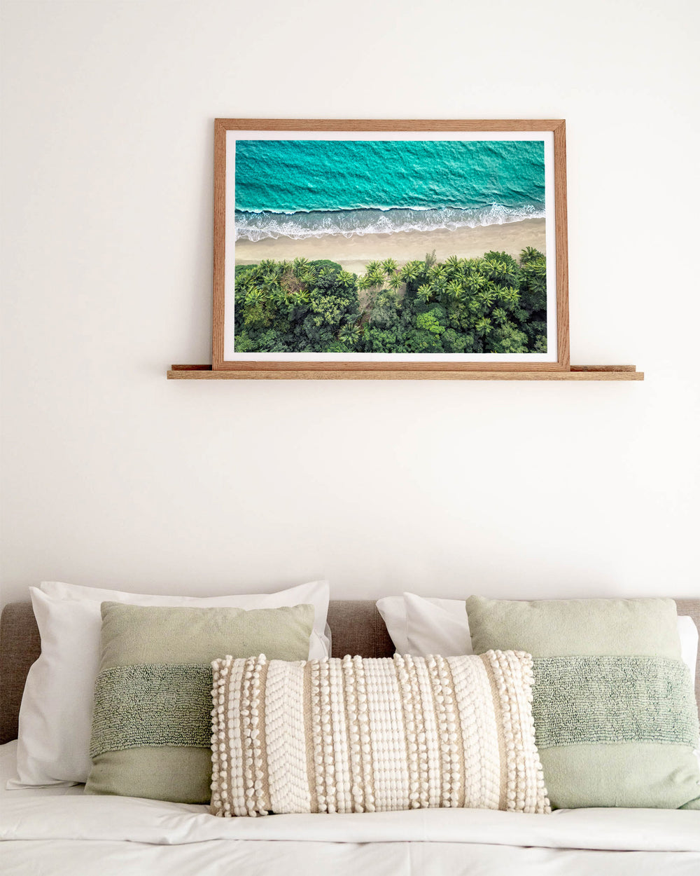 Emerald Tide – Four Mile Beach, Aerial Photography by David Lloyd, framed paper print in oak frame, styled in a bedroom setting