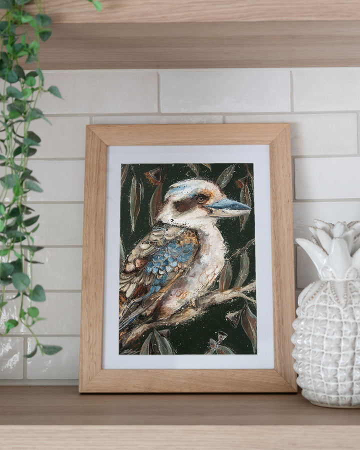 Fablewood kookaburra fine art print by Stephanie Elizabeth, framed paper print in an oak frame on a kitchen shelf