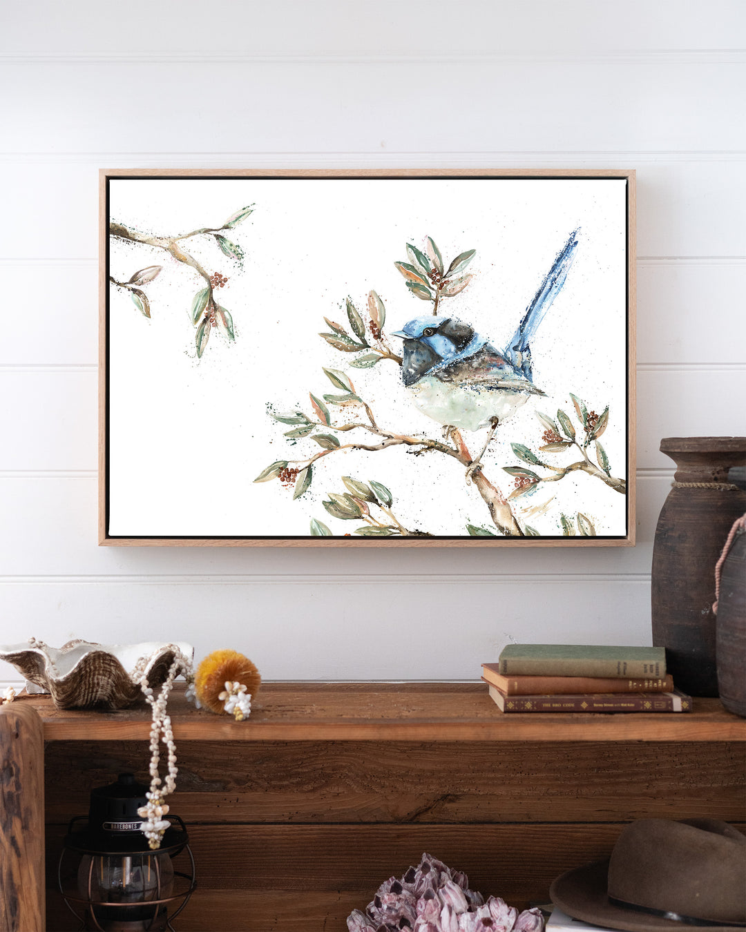 Fairy Floss fairy wren fine art print by Stephanie Elizabeth, framed canvas in an oak frame above a bookshelf