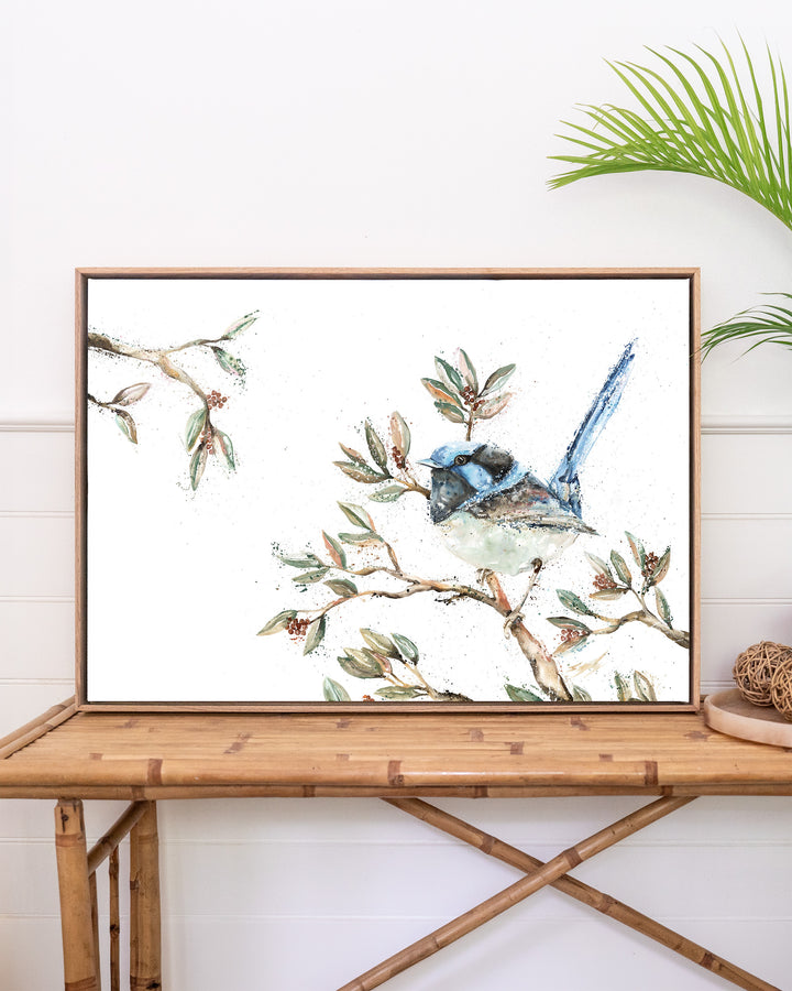 Fairy Floss fairy wren fine art print by Stephanie Elizabeth, framed canvas in an oak frame above a rattan table