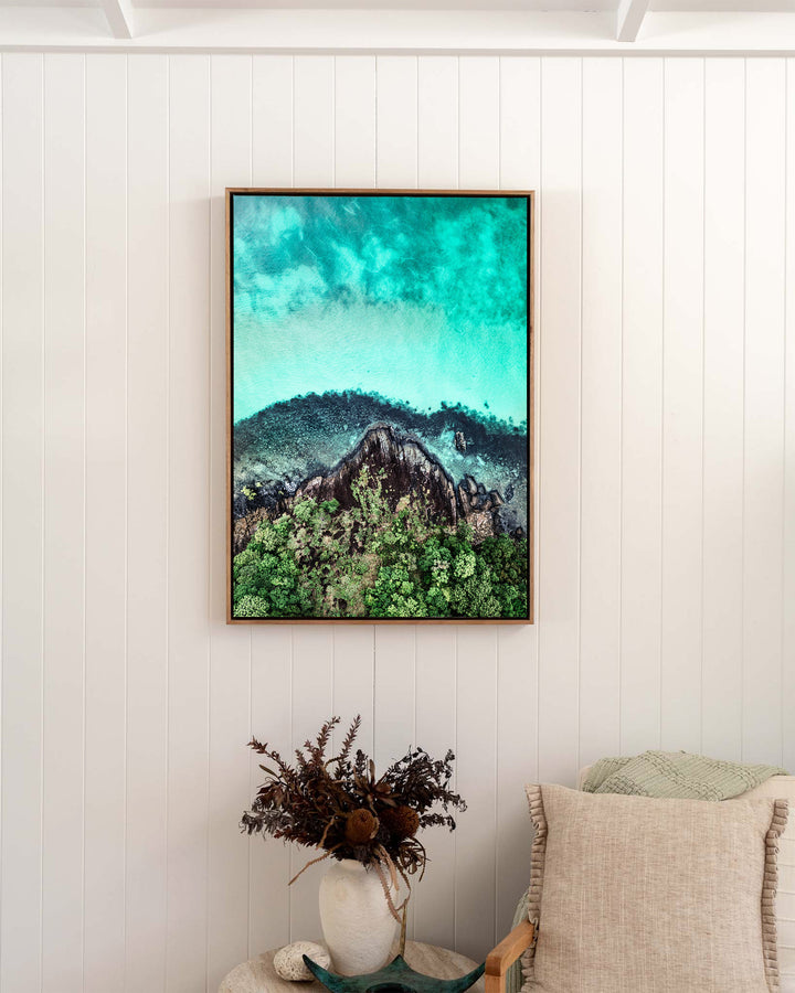 Fall At Your Feet – Cape Tribulation, Aerial Photography by David Lloyd, framed canvas print in oak float frame, styled in a bedroom setting