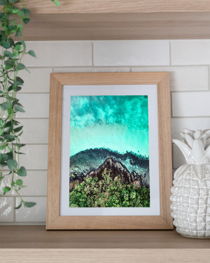 Fall At Your Feet – Cape Tribulation, Aerial Photography by David Lloyd, framed paper print in oak frame, styled in a kitchen shelf setting