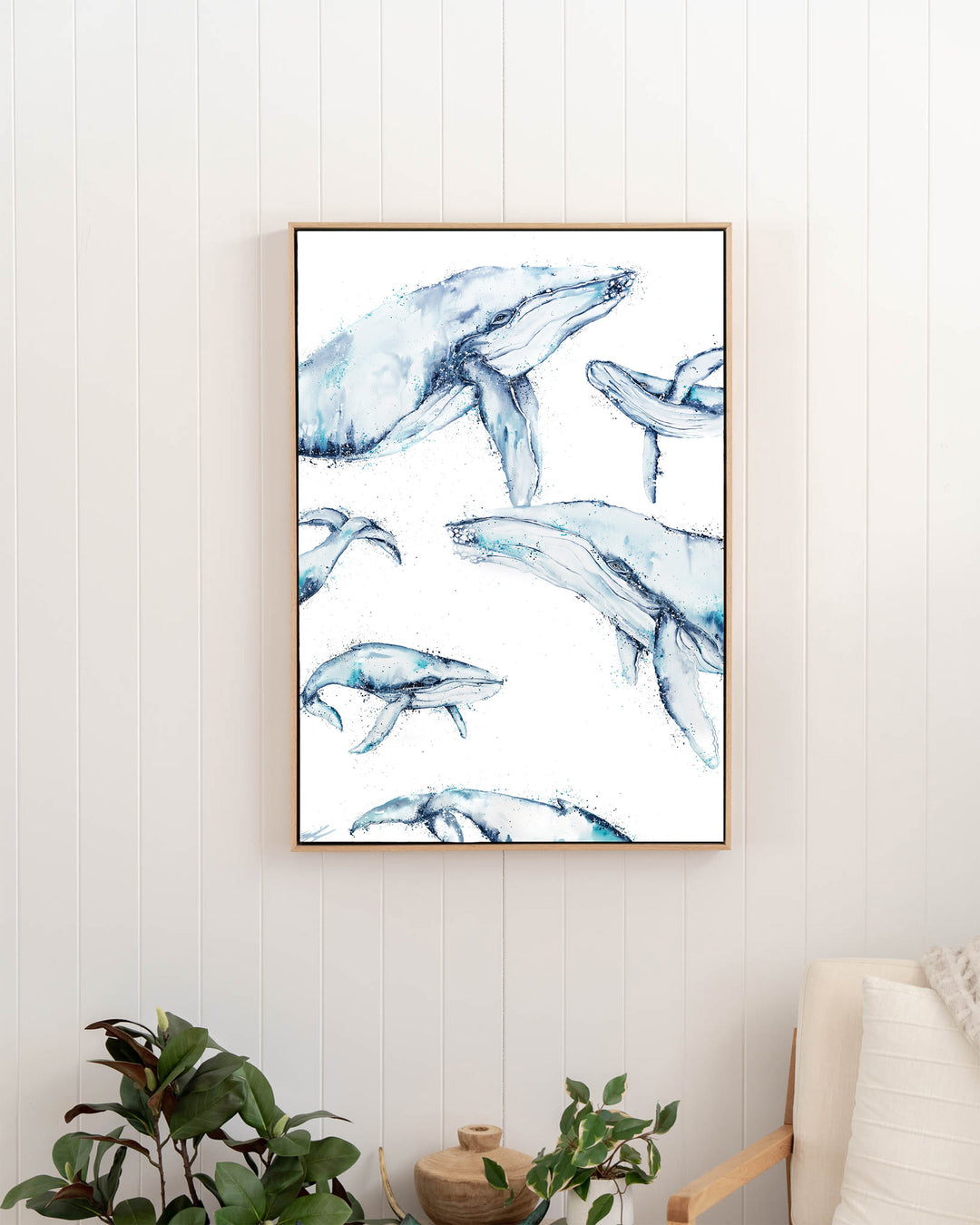 Family Trip humpback whales fine art print by Stephanie Elizabeth, framed canvas in an oak frame in a hallway