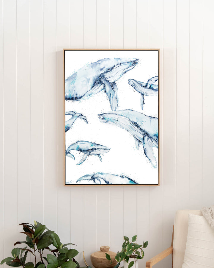 Family Trip humpback whales fine art print by Stephanie Elizabeth, framed canvas in an oak frame in a hallway