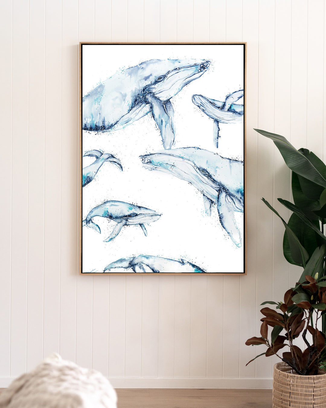 Family Trip humpback whales fine art print by Stephanie Elizabeth, framed canvas in an oak frame in a living room