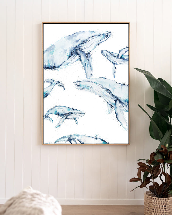 Family Trip humpback whales fine art print by Stephanie Elizabeth, framed canvas in an oak frame in a living room