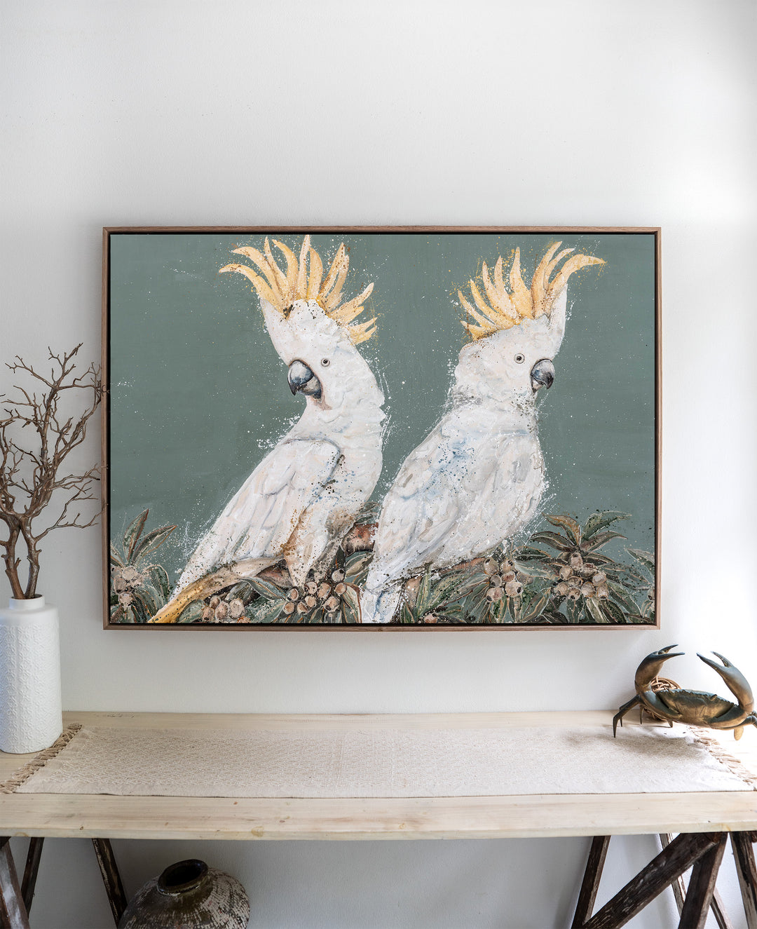 Feathers and Mayhem – white cockatoos, framed canvas in oak float frame, styled above a side table