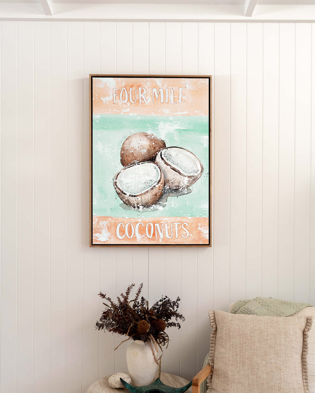 Four Mile Coconuts – tropical still life of coconuts, framed canvas in oak float frame, styled in a bedroom