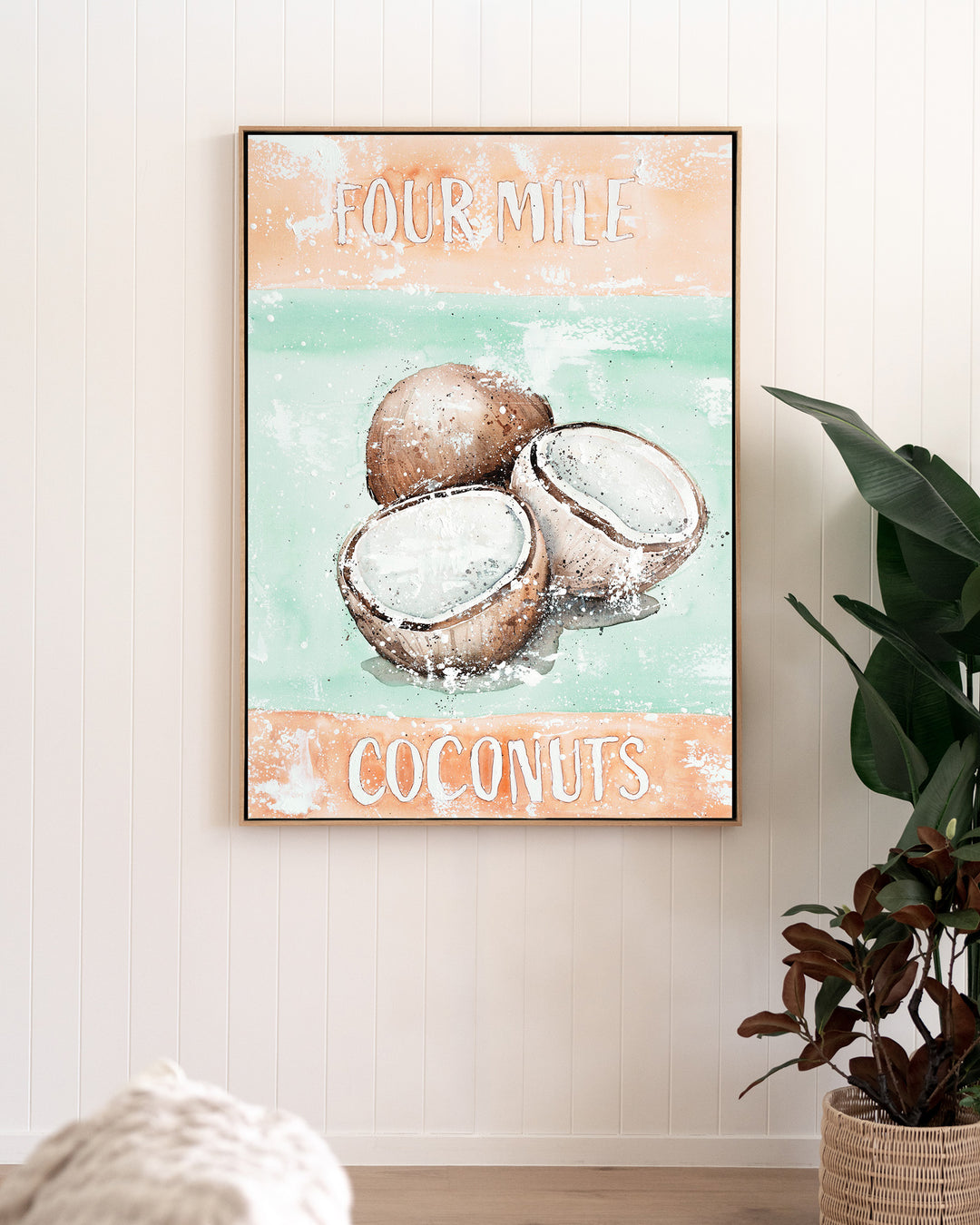Four Mile Coconuts – tropical still life of coconuts, framed canvas in oak float frame, styled in a living room