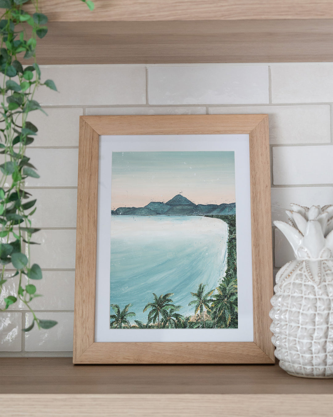 From the Lookout landscape fine art print by Stephanie Elizabeth, framed paper print in an oak frame on a kitchen shelf