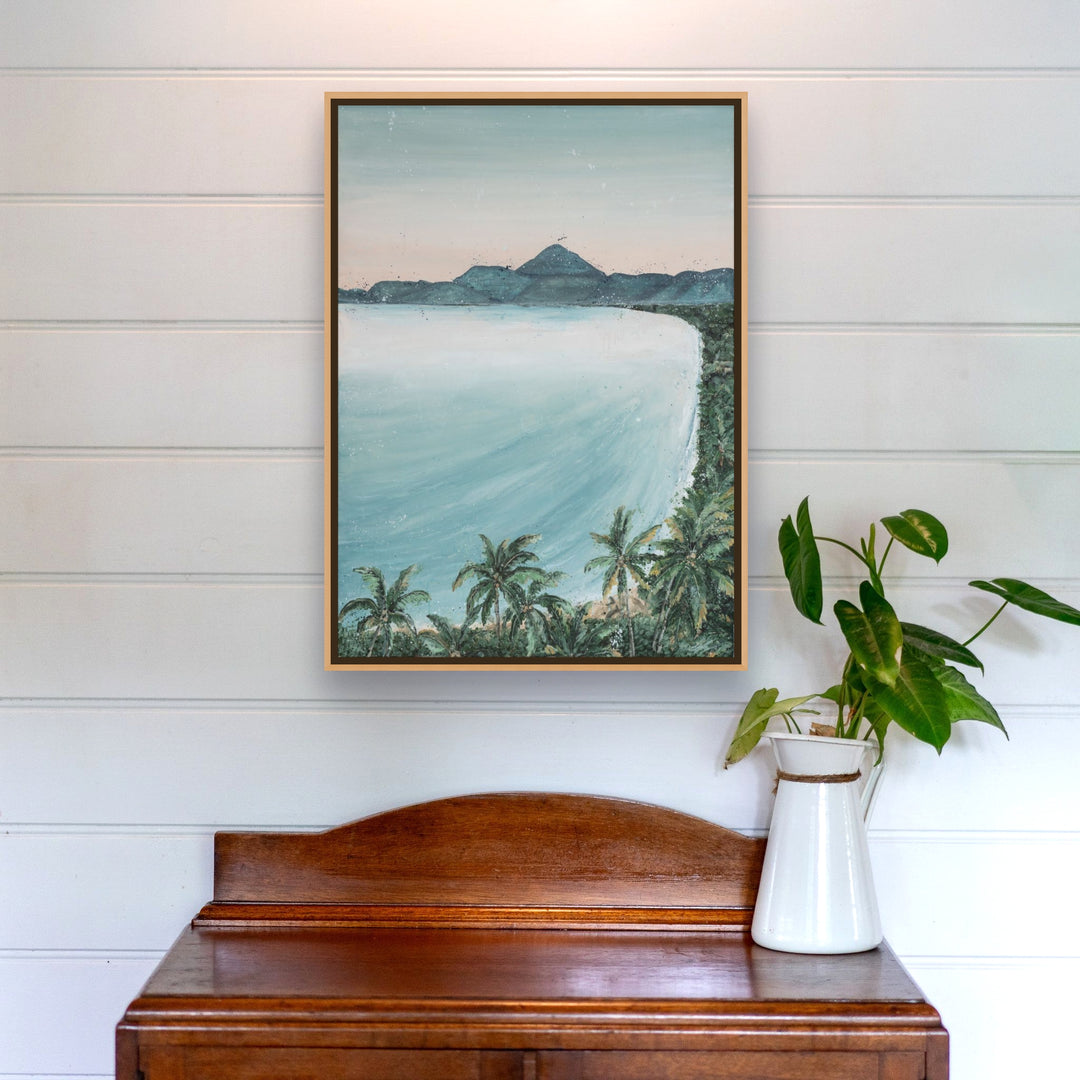 From the Lookout landscape print above a wooden desk with a potted plant.
